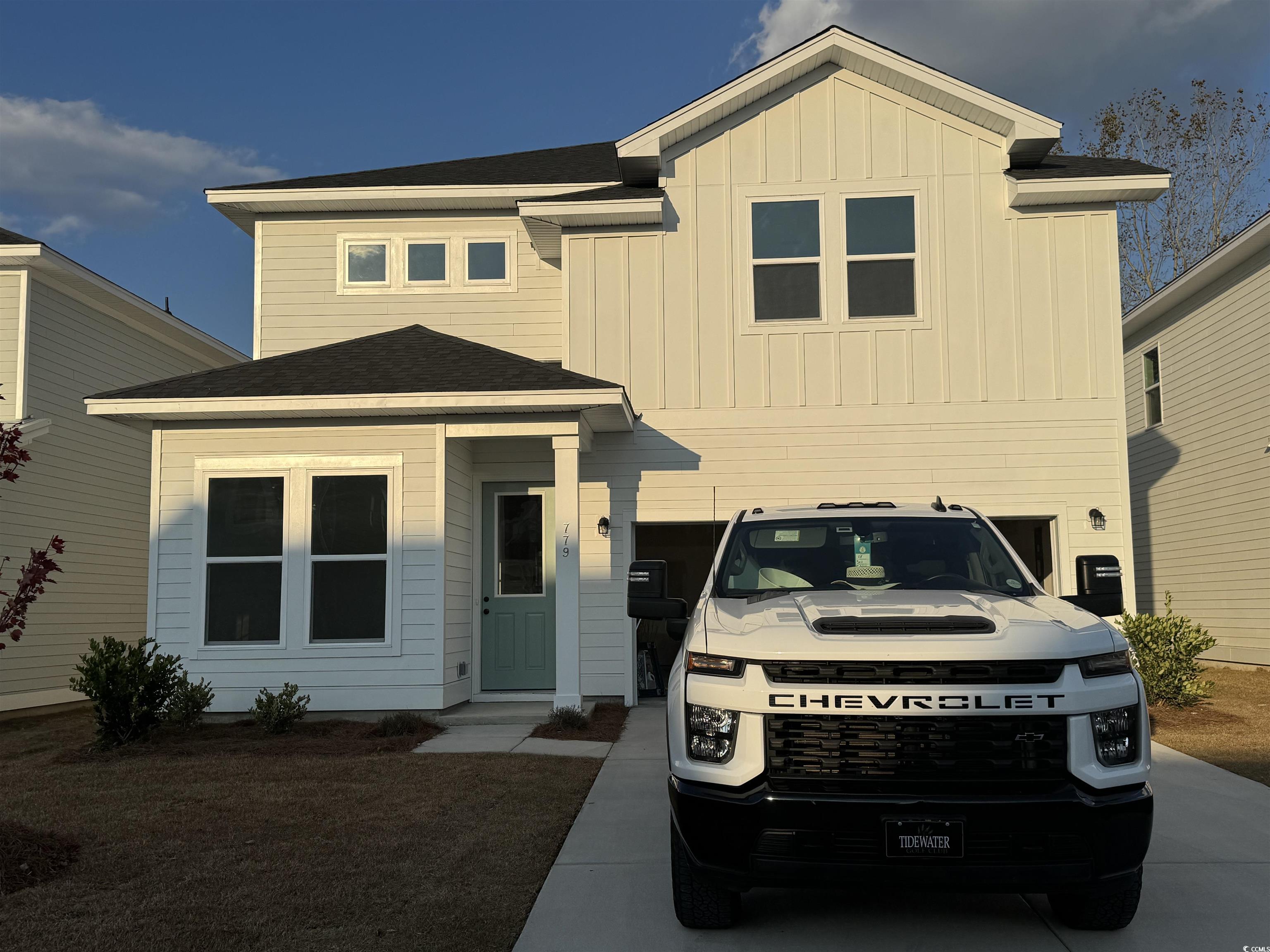 779 Ebb Tide Road Little River, SC 29566 - Photo 1 of 4 View of front of property with board and batten siding, a shingled roof, driveway, and an attached garage