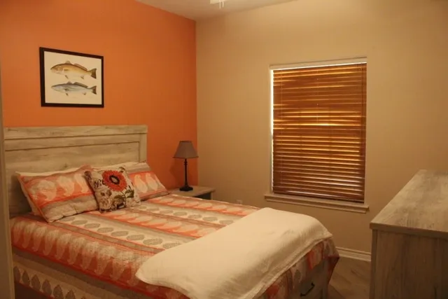 a bedroom with a bed and a painting on the wall