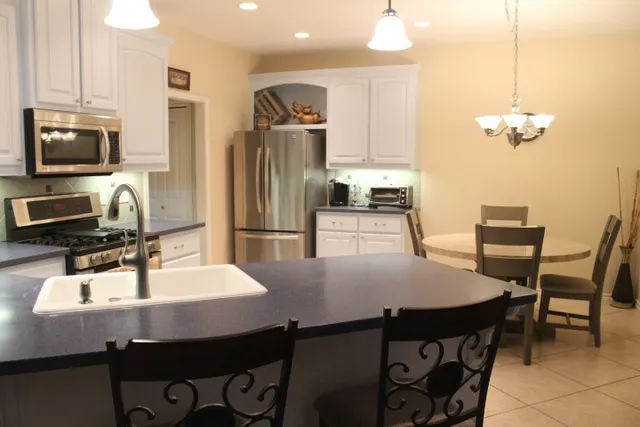 a kitchen with a dining table and chairs