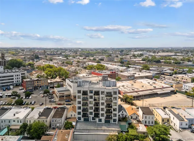 an aerial view of residential building with parking