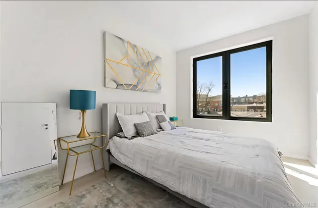 a bedroom with a bed and window