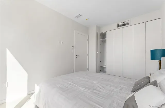 a bedroom with a bed and a cabinets