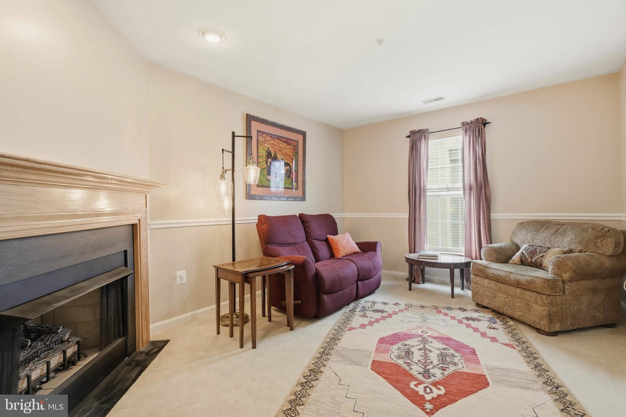 8721 Spring Brook Way Odenton, MD 21113 - Photo 17 of 40 a living room with furniture and a fireplace
