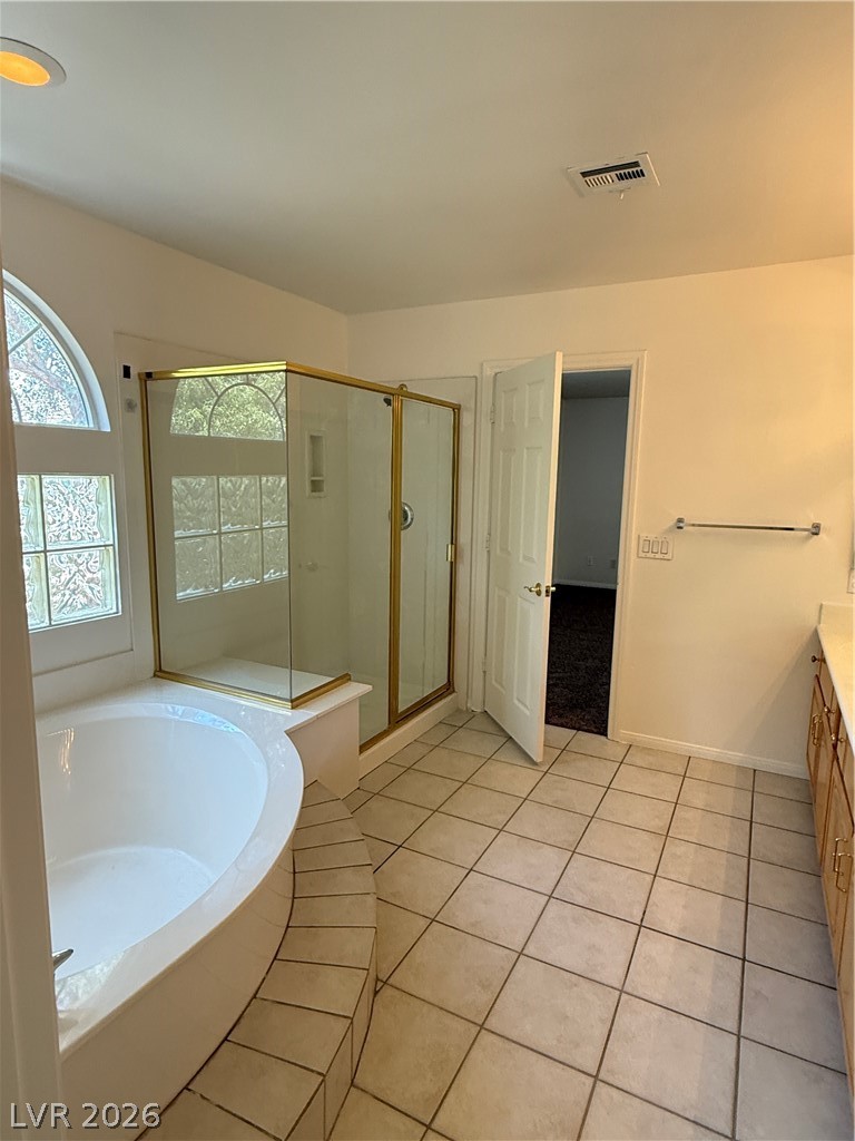 10975 Calcedonian Street Las Vegas, NV 89141 - Photo 20 of 25 This serene bathroom offers a luxurious soaking tub and separate shower, perfect for unwinding.