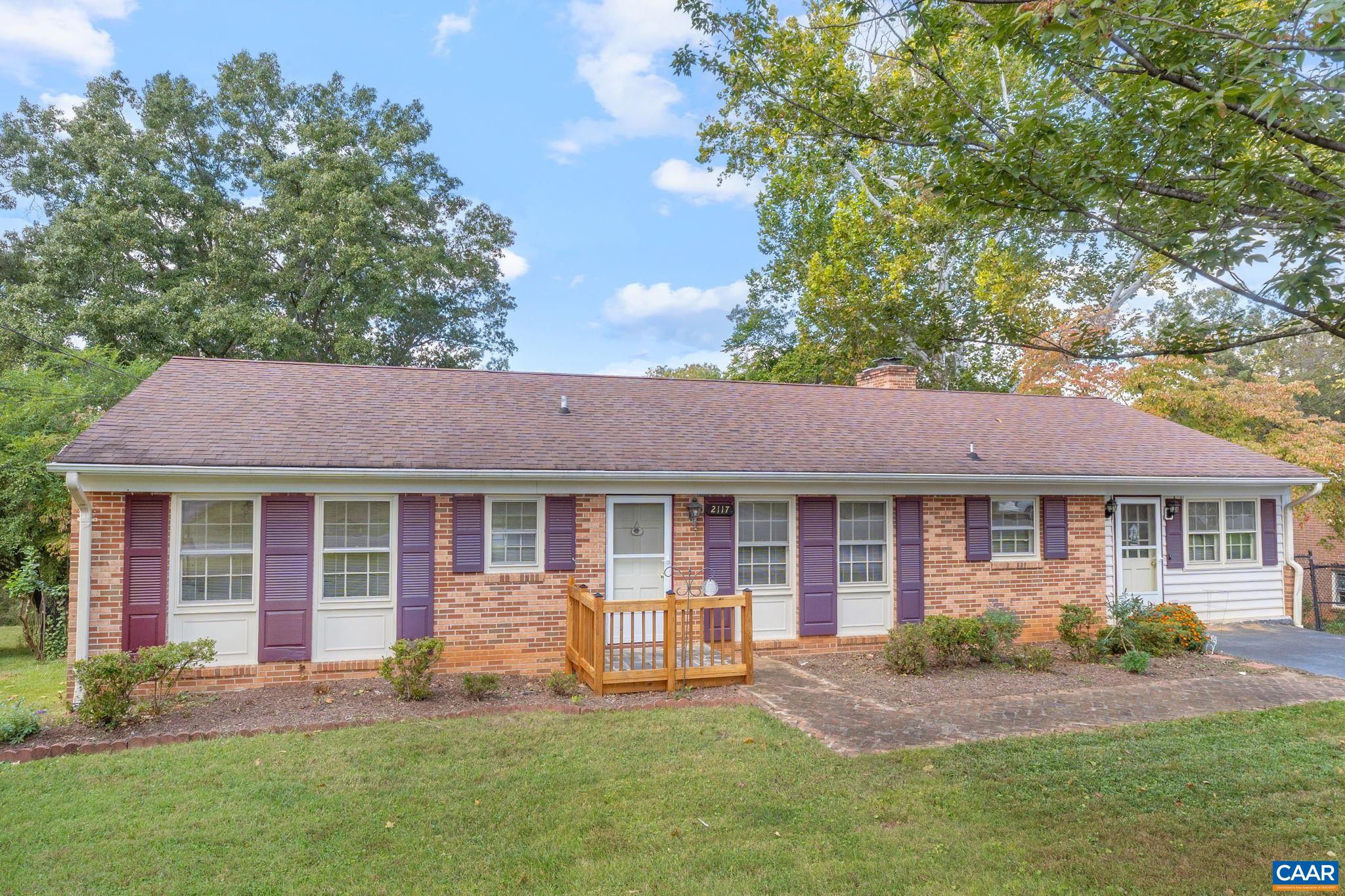 a front view of a house with a yard and porch
