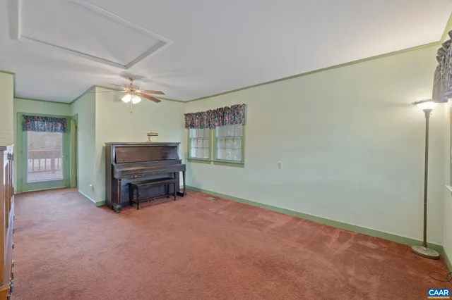 a view of a livingroom with furniture and a ceiling fan