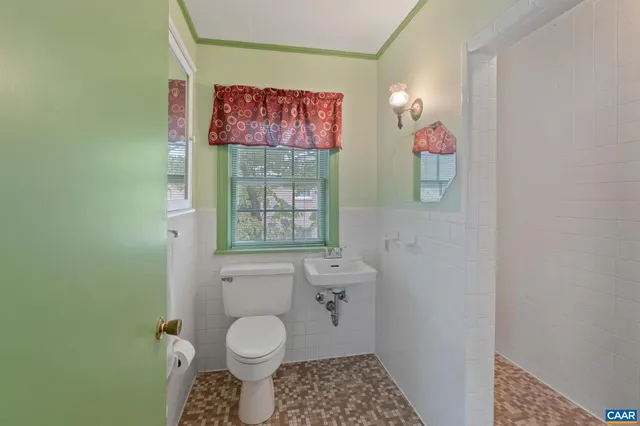 a bathroom with a toilet a sink and shower