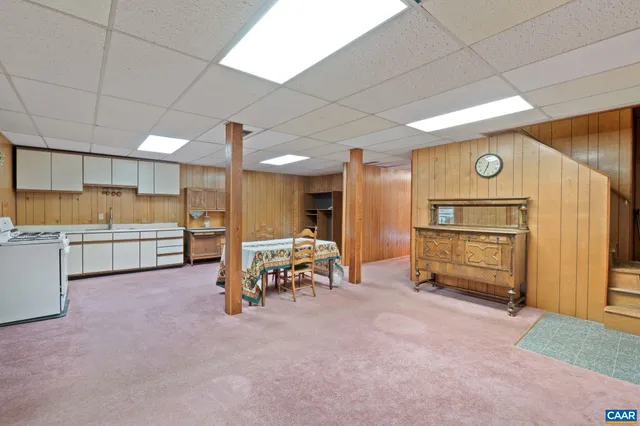 a view of a livingroom with furniture and a refrigerator