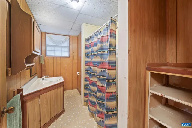 a bathroom with a sink a vanity and a shower