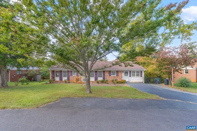 a view of a house with a yard and sitting area