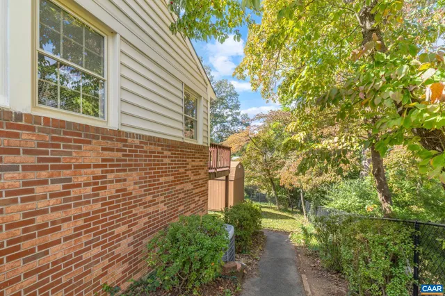 a view of a chair and table in the backyard
