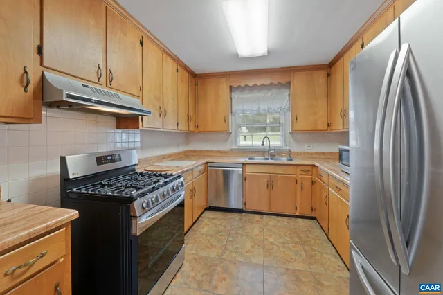 a kitchen with a sink stove and refrigerator