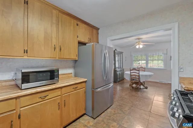 a kitchen with a refrigerator and cabinets