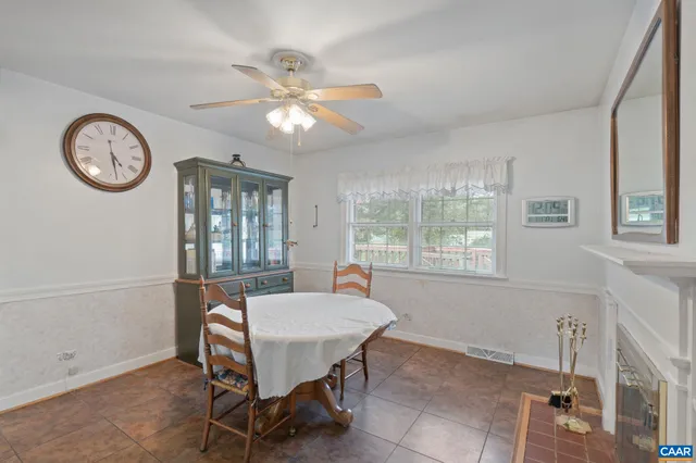 a view of a dining room with furniture and a large window