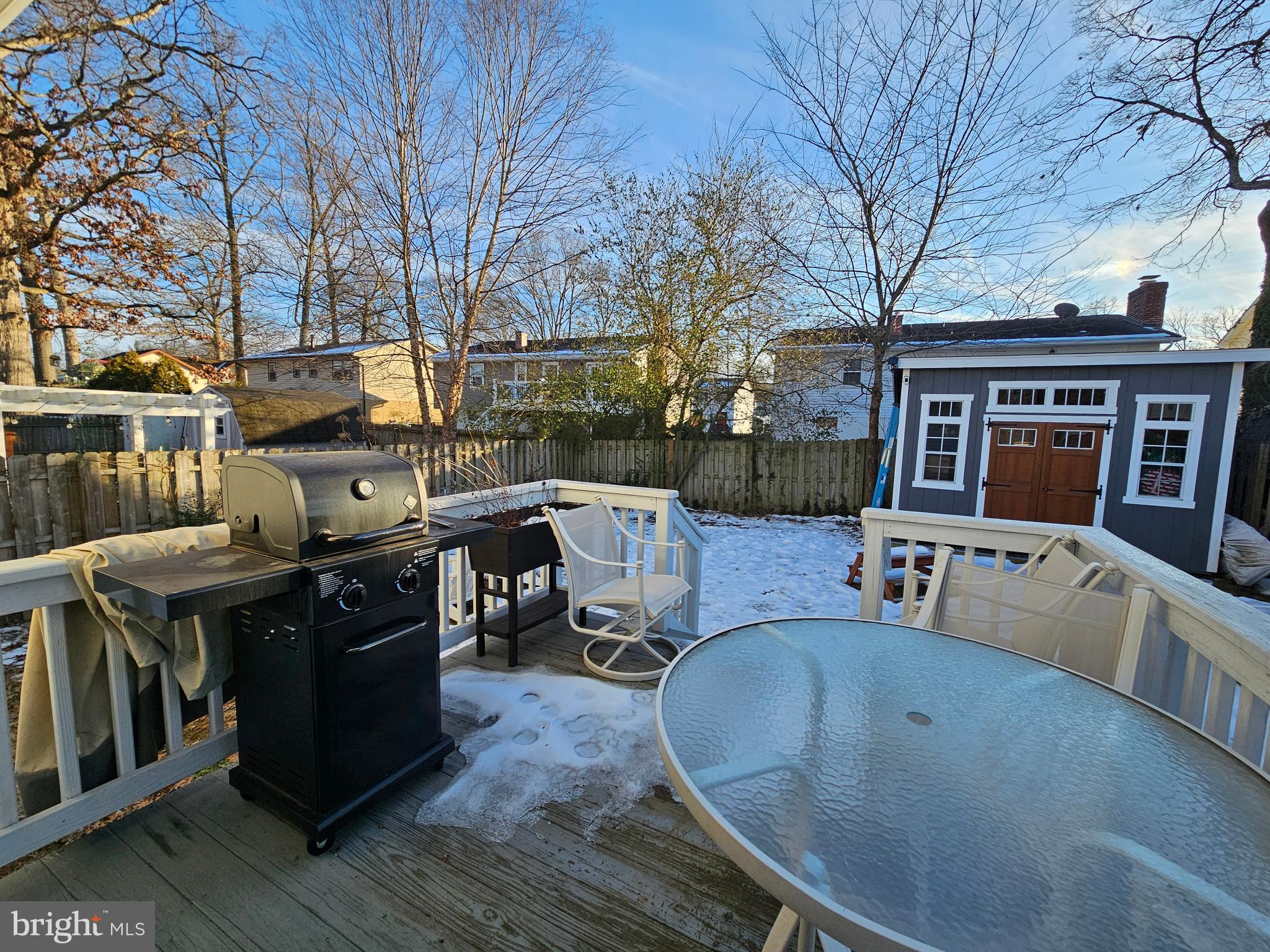 413 Cedar Grove Road Edgewater, MD 21037 - Photo 21 of 30 a view of a patio with table and chairs with wooden floor and fence