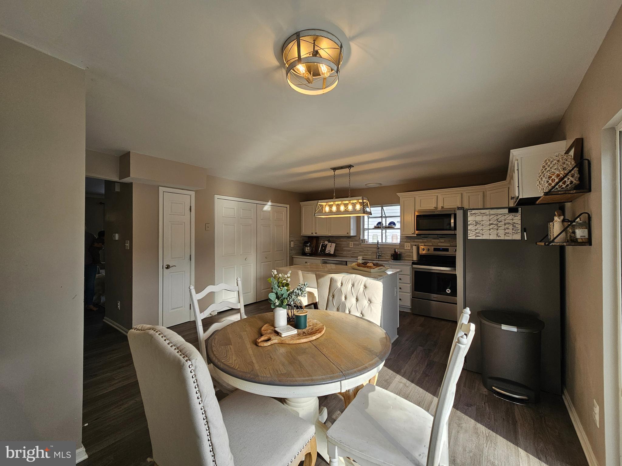 413 Cedar Grove Road Edgewater, MD 21037 - Photo 7 of 30 a dining room with furniture and a kitchen view