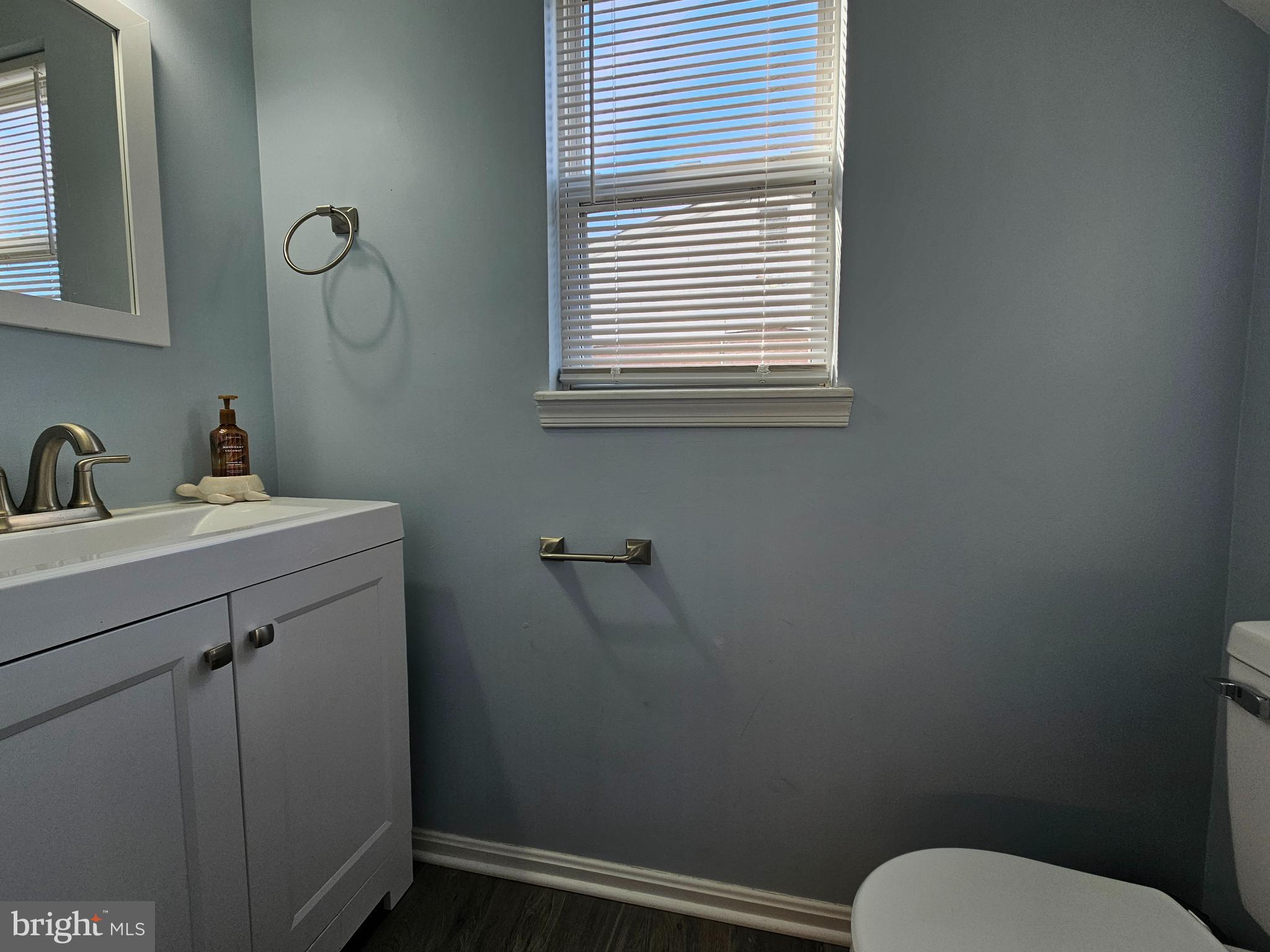 413 Cedar Grove Road Edgewater, MD 21037 - Photo 9 of 30 a bathroom with a toilet sink and mirror