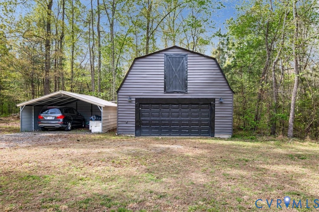 9820 Beaver Bridge Road Chesterfield, VA 23838 - Photo 49 of 54 Gray barn-style outbuilding with a garage door and