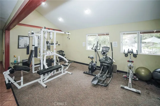 a room with gym equipment and windows