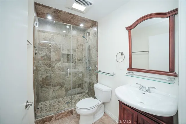 a bathroom with a sink toilet and shower