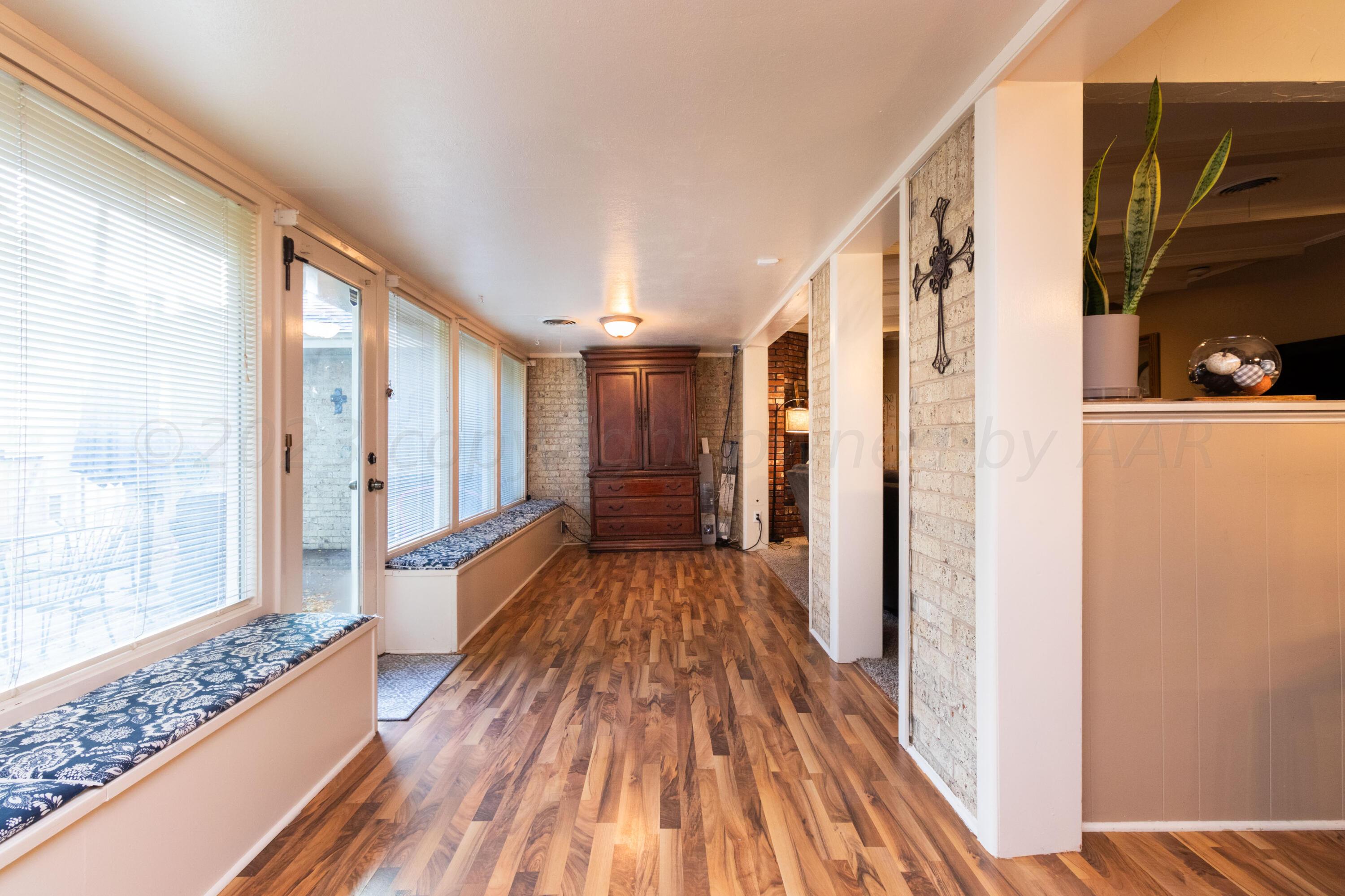 6704 Elmhurst Road Amarillo, TX 79106 - Photo 12 of 40 a view of a hallway with wooden floor and staircase