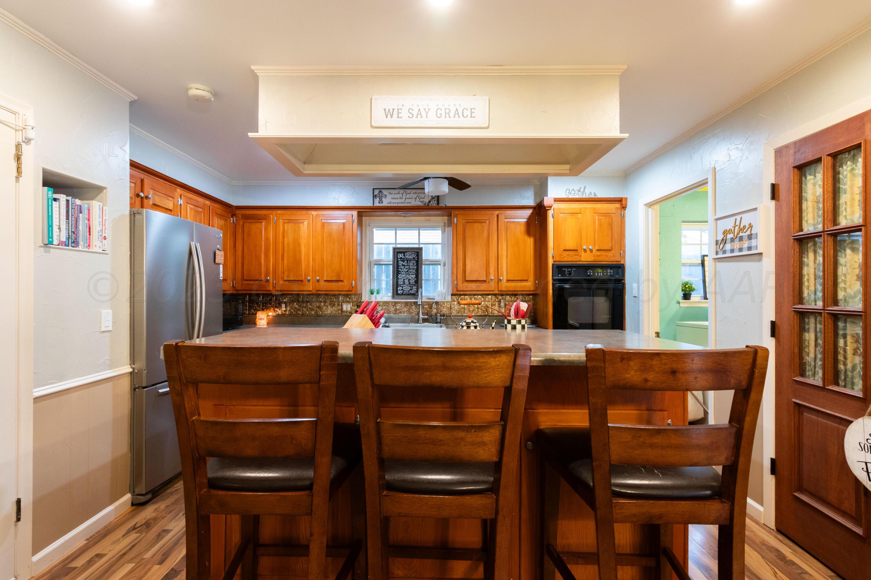 6704 Elmhurst Road Amarillo, TX 79106 - Photo 19 of 40 a dining hall with stainless steel appliances granite countertop a dining table and chairs