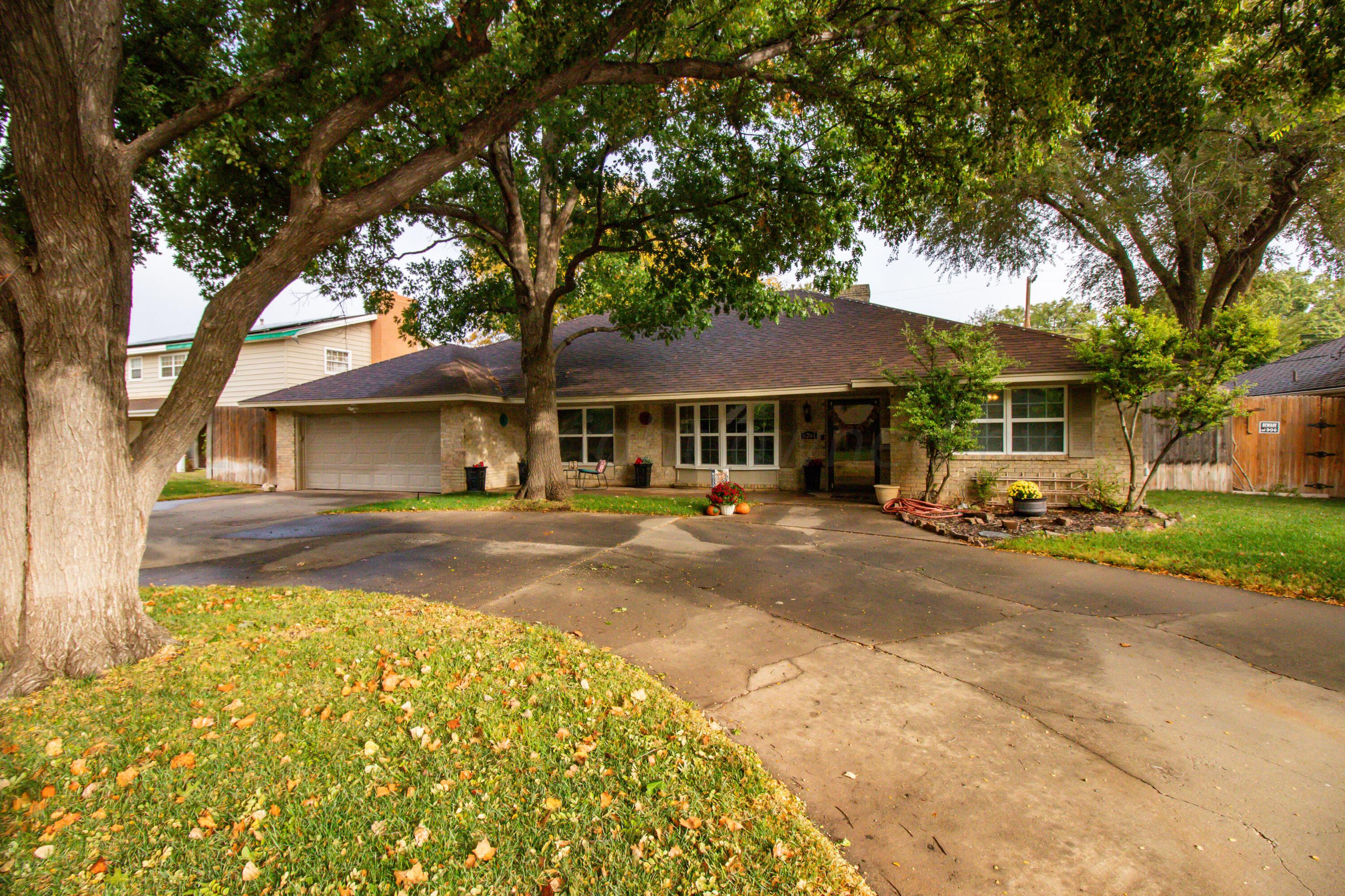 6704 Elmhurst Road Amarillo, TX 79106 - Photo 2 of 40 a front view of a house with a yard and garage