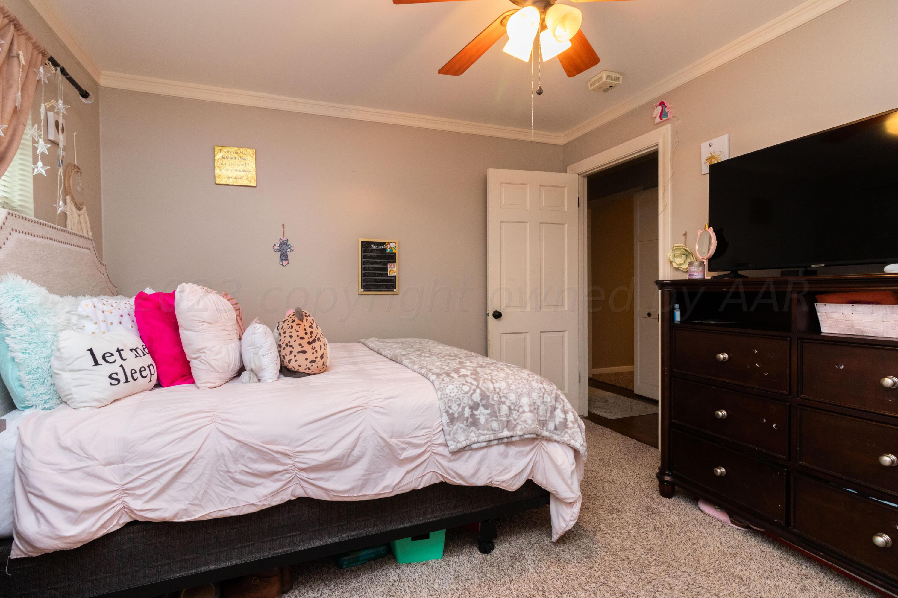 6704 Elmhurst Road Amarillo, TX 79106 - Photo 25 of 40 a bedroom with a bed and a flat screen tv