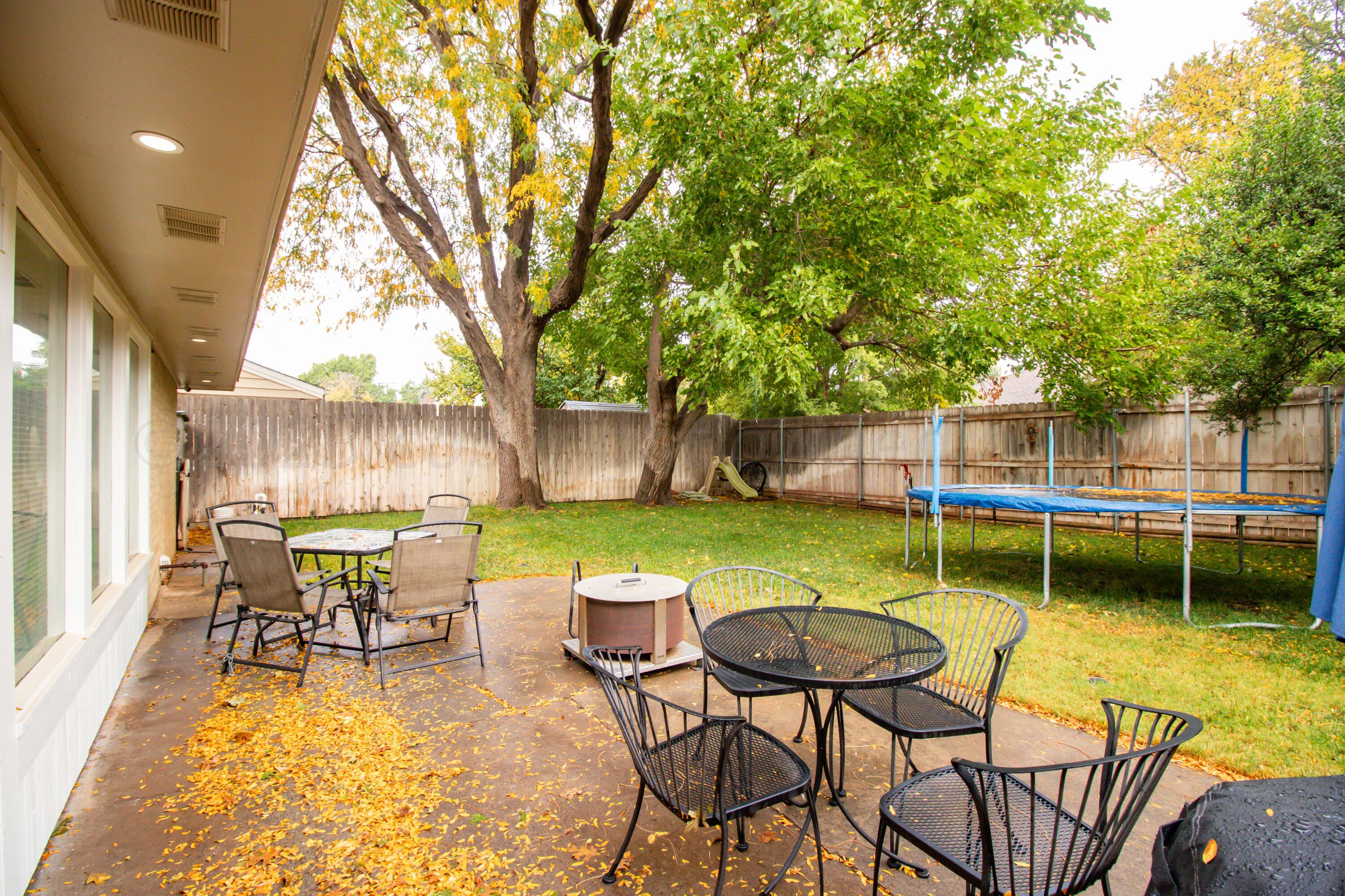 6704 Elmhurst Road Amarillo, TX 79106 - Photo 36 of 40 a view of a house with backyard porch and sitting area