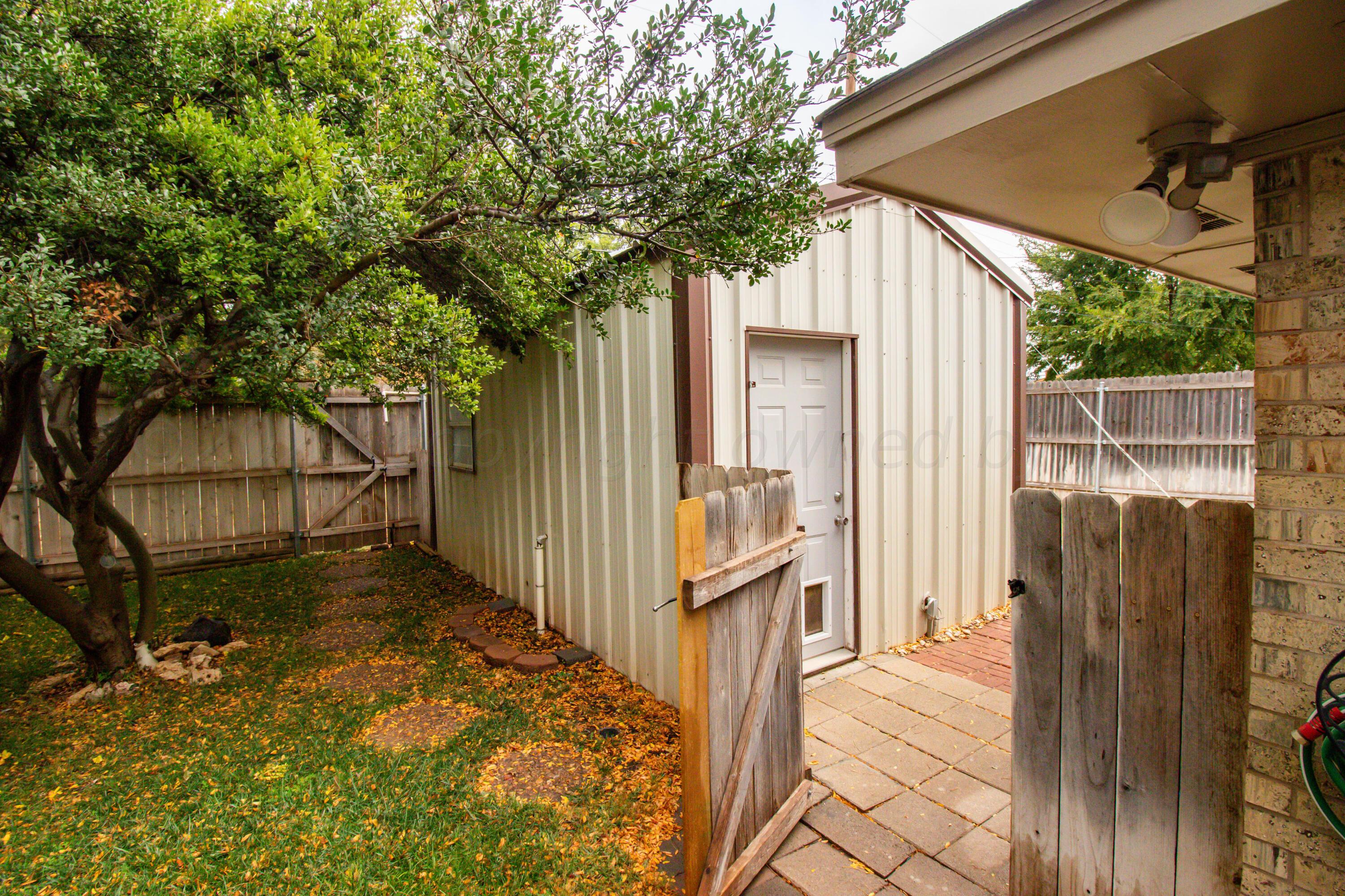 6704 Elmhurst Road Amarillo, TX 79106 - Photo 38 of 40 a view of a house with a small yard and wooden fence
