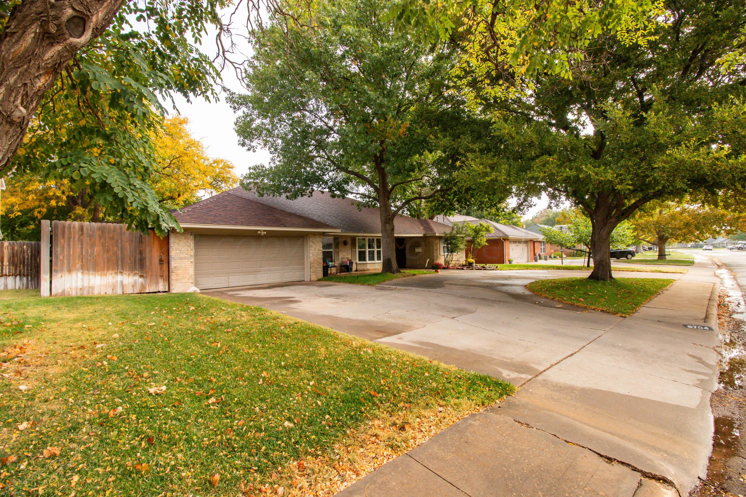 6704 Elmhurst Road Amarillo, TX 79106 - Photo 4 of 40 a view of a house with a yard and tree s