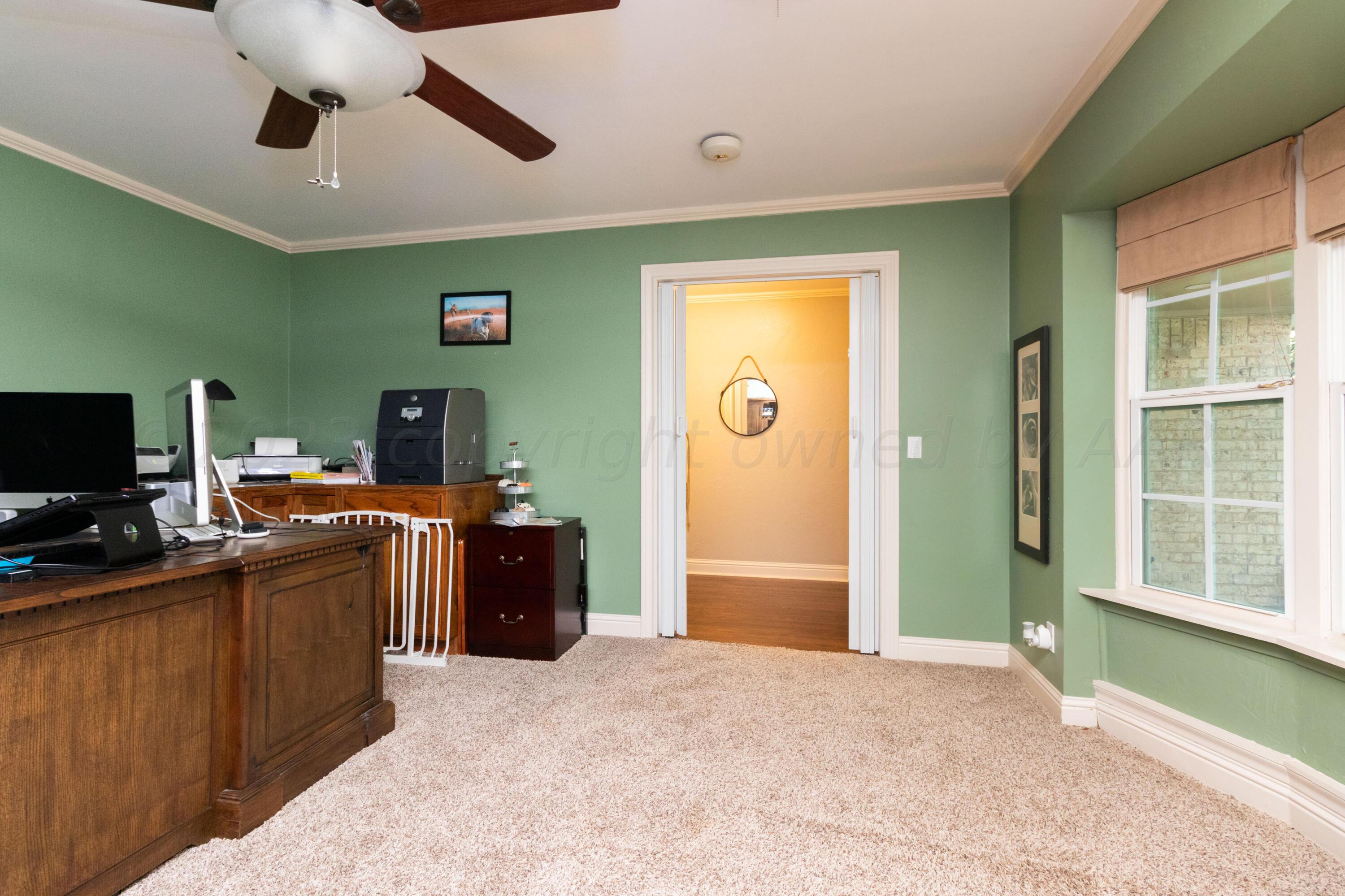 6704 Elmhurst Road Amarillo, TX 79106 - Photo 7 of 40 a bedroom with a bed and a television