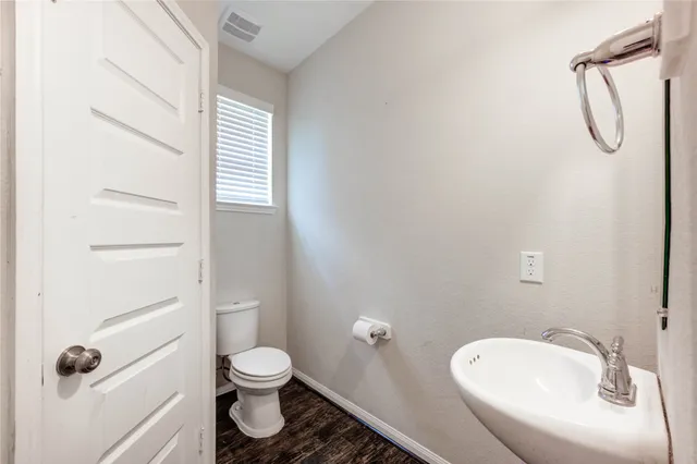 a bathroom with a toilet sink and shower