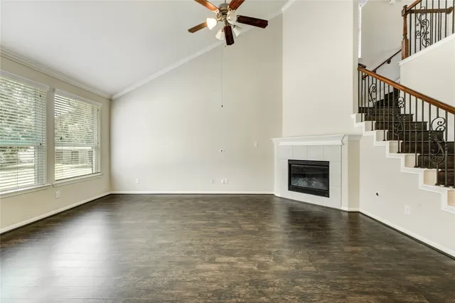 a view of empty room with fireplace and wooden floor