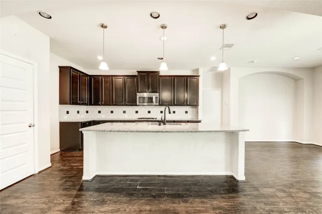 a view of kitchen with wooden floor and window