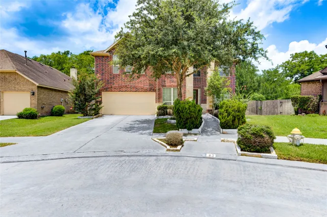 a view of a house with a garden and pathway