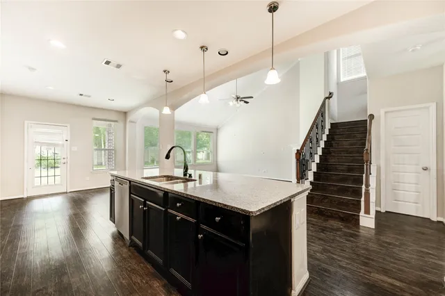 a kitchen with sink and wooden floor