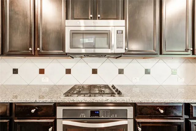 a stove top oven sitting inside of a kitchen