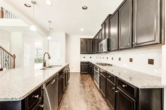 a kitchen with stainless steel appliances granite countertop counter space a sink and cabinets