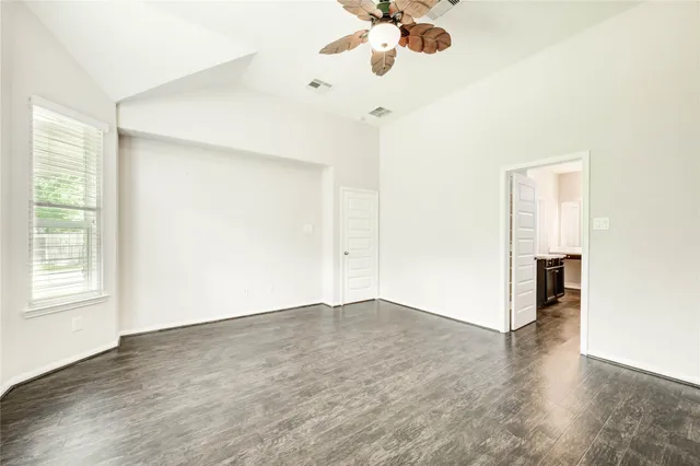 wooden floor in an empty room with a window