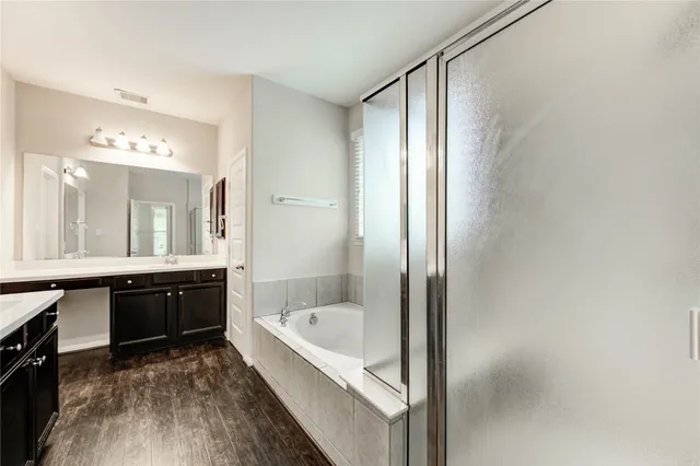 a large bathroom with a bathtub and a sink