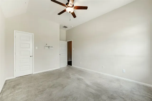 a view of a room with a ceiling fan