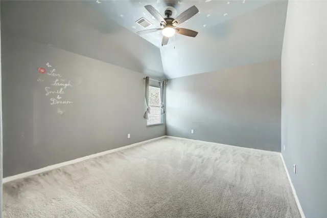 en empty room with window and ceiling fan