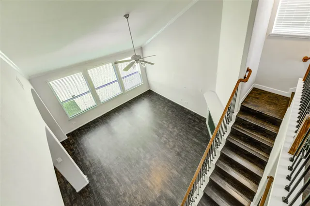 a view of an empty room with staircase