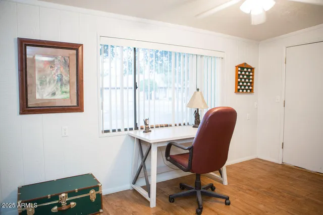 a view of a workspace with furniture and a window
