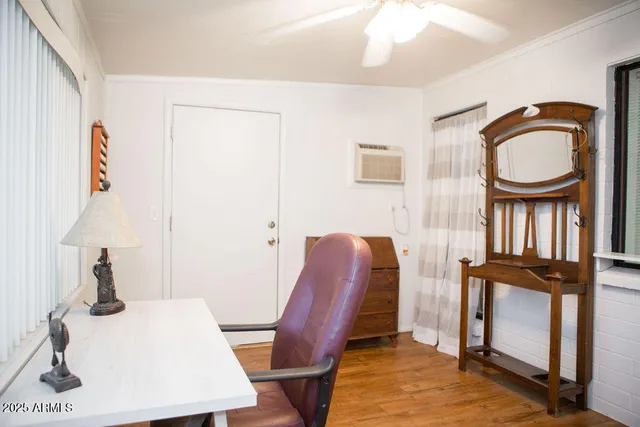a view of a workspace with furniture and a window