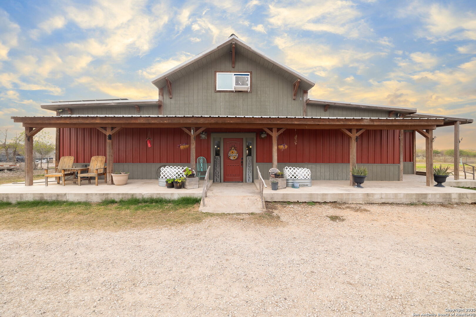 918 County Road 5710 Devine, TX 78016 - Photo 1 of 46 a view of a white house with swimming pool and a large tree