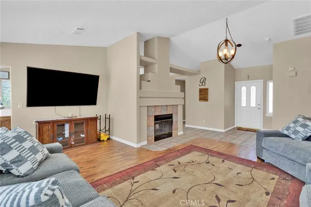 a living room with a flat screen tv and a fireplace