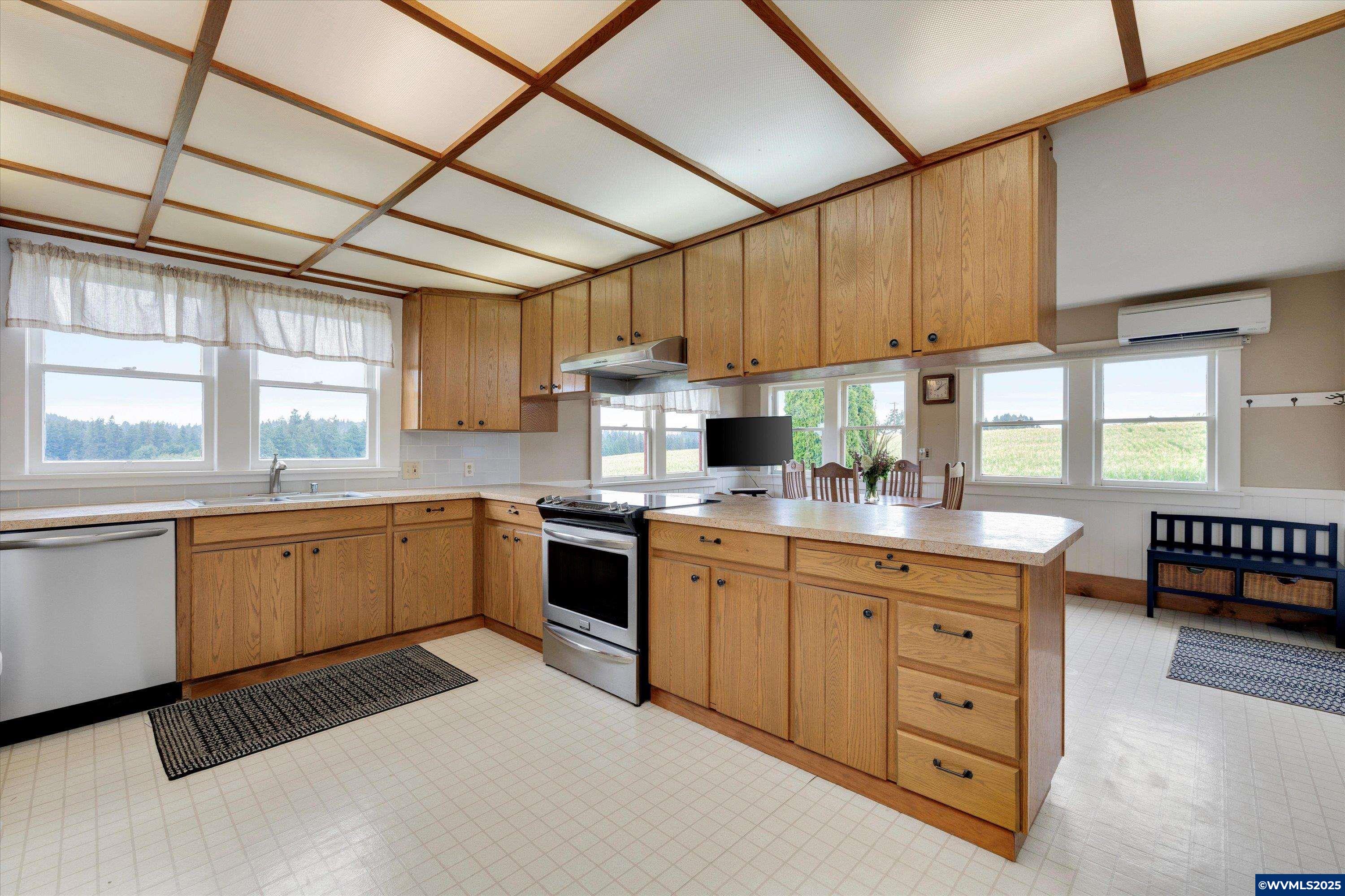 21303 South Central Point Road Canby, OR 97013 - Photo 40 of 50 a kitchen with granite countertop a sink stainless steel appliances and cabinets