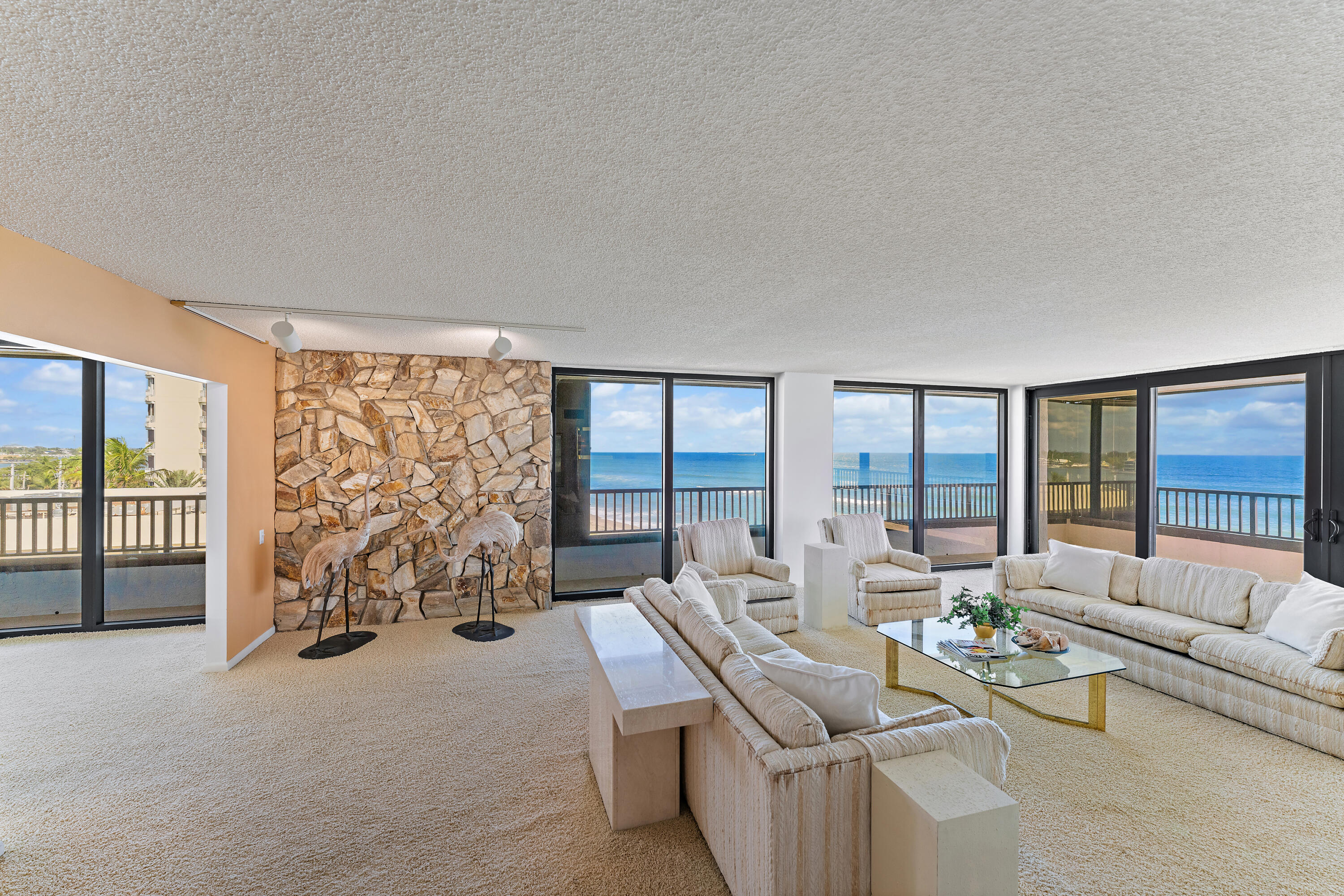 19900 South Beach Road, Unit 601 Jupiter, FL 33469 - Photo 11 of 84 a living room with furniture and large windows